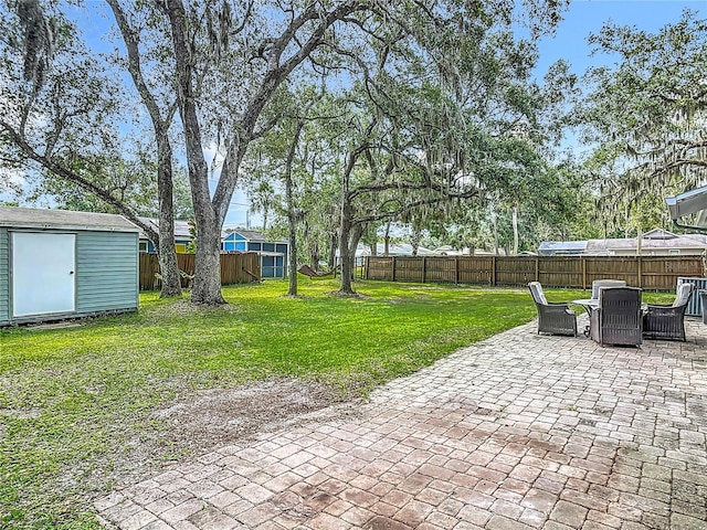 1331 Needle Palm Dr, Edgewater, FL 32132 - fenced backyard featuring a patio area, a shed, and outdoor dining area