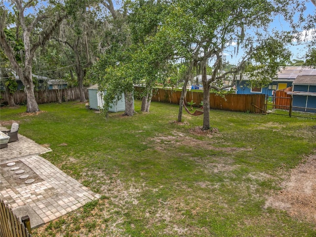 1331 Needle Palm Dr, Edgewater, FL 32132 - fenced backyard with a storage unit and a patio area