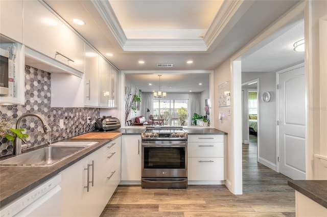 325 N Causeway Unit B305, New Smyrna Beach, FL 32169 - kitchen with electric range, dishwasher, ornamental molding, white cabinets, and decorative backsplash