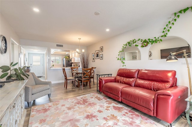 325 N Causeway Unit B305, New Smyrna Beach, FL 32169 - living area with wood finished floors, a chandelier, and recessed lighting