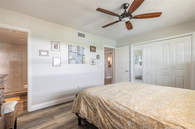 325 N Causeway Unit B305, New Smyrna Beach, FL 32169 - bedroom featuring wood finished floors, a closet, ensuite bathroom, and a ceiling fan