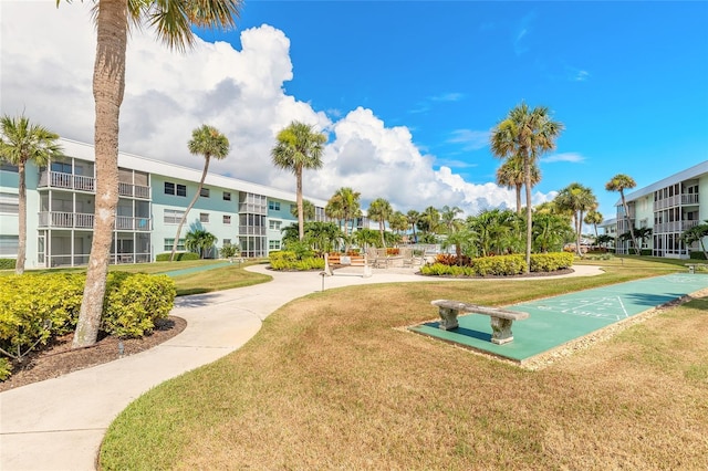 325 N Causeway Unit B305, New Smyrna Beach, FL 32169 - surrounding community with shuffleboard and a yard