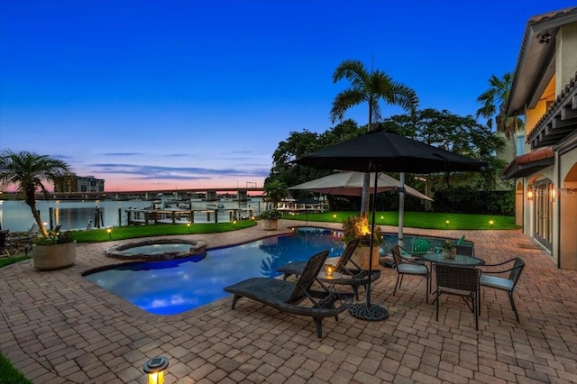 206 Canova Dr, New Smyrna Beach, FL 32169 - pool at dusk featuring a patio area and a pool with connected hot tub
