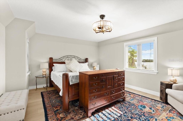 206 Canova Dr, New Smyrna Beach, FL 32169 - bedroom with a chandelier and wood finished floors