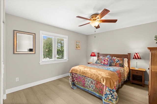 206 Canova Dr, New Smyrna Beach, FL 32169 - bedroom with wood finished floors and ceiling fan