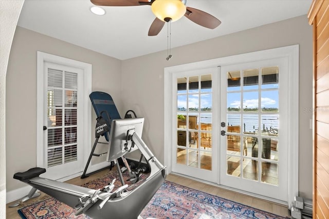 206 Canova Dr, New Smyrna Beach, FL 32169 - exercise area featuring french doors, a water view, a ceiling fan, and wood finished floors