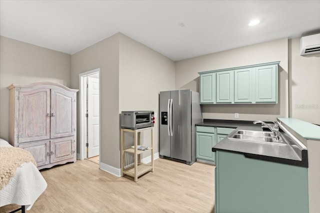 206 Canova Dr, New Smyrna Beach, FL 32169 - kitchen with stainless steel fridge with ice dispenser, light wood-style floors, a wall mounted air conditioner, recessed lighting, and dark countertops