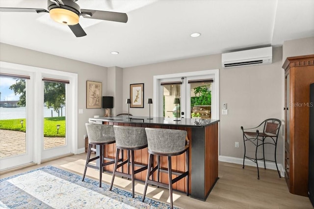 206 Canova Dr, New Smyrna Beach, FL 32169 - kitchen featuring a wall mounted AC, plenty of natural light, a kitchen breakfast bar, ceiling fan, and recessed lighting