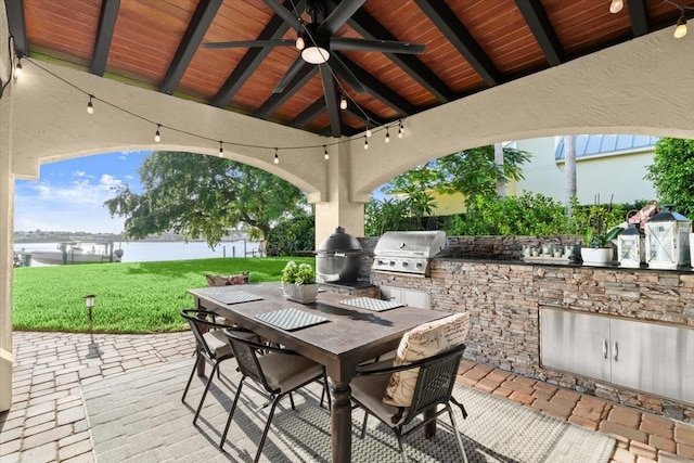 206 Canova Dr, New Smyrna Beach, FL 32169 - view of patio / terrace with area for grilling, outdoor dining area, a ceiling fan, and a water view