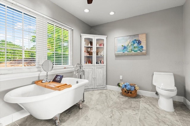 206 Canova Dr, New Smyrna Beach, FL 32169 - bathroom with a freestanding bath, marble look tiles, and recessed lighting
