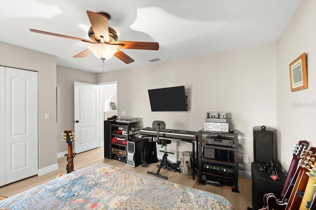 206 Canova Dr, New Smyrna Beach, FL 32169 - bedroom with a ceiling fan, wood finished floors, and a closet