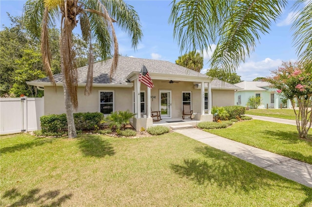 527 Old Minorcan Trl, New Smyrna Beach, FL 32168 - view of front of house with stucco siding, ceiling fan, a shingled roof, and a porch