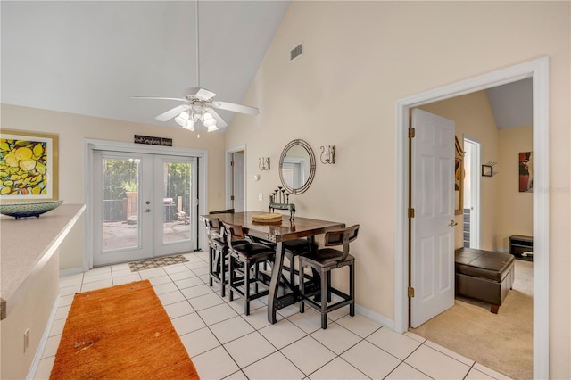 527 Old Minorcan Trl, New Smyrna Beach, FL 32168 - dining space with french doors, light tile patterned floors, a ceiling fan, and high vaulted ceiling