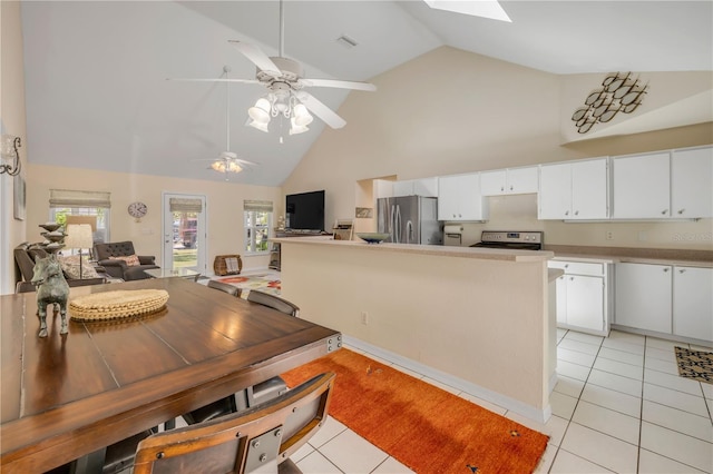 527 Old Minorcan Trl, New Smyrna Beach, FL 32168 - dining room featuring high vaulted ceiling, light tile patterned floors, ceiling fan, and a skylight