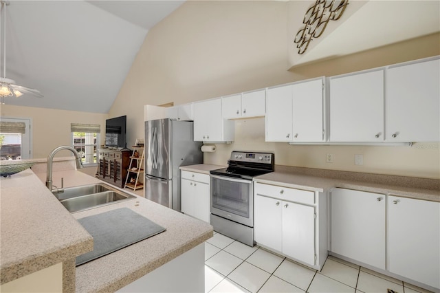 527 Old Minorcan Trl, New Smyrna Beach, FL 32168 - kitchen featuring stainless steel appliances, high vaulted ceiling, light countertops, white cabinets, and light tile patterned flooring