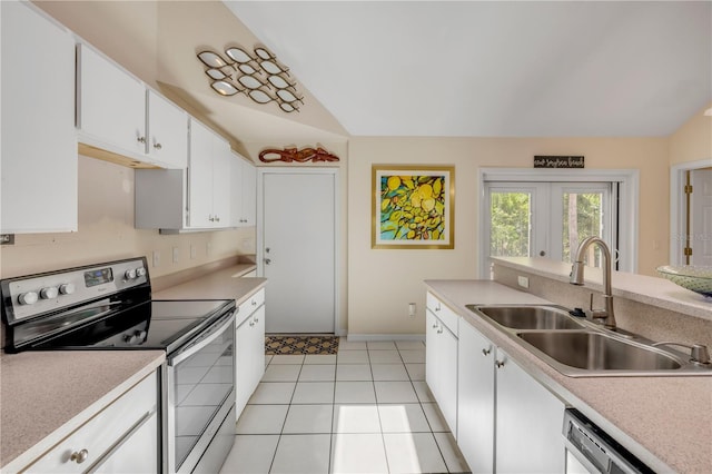 527 Old Minorcan Trl, New Smyrna Beach, FL 32168 - kitchen featuring stainless steel electric stove, dishwasher, light countertops, white cabinetry, and lofted ceiling