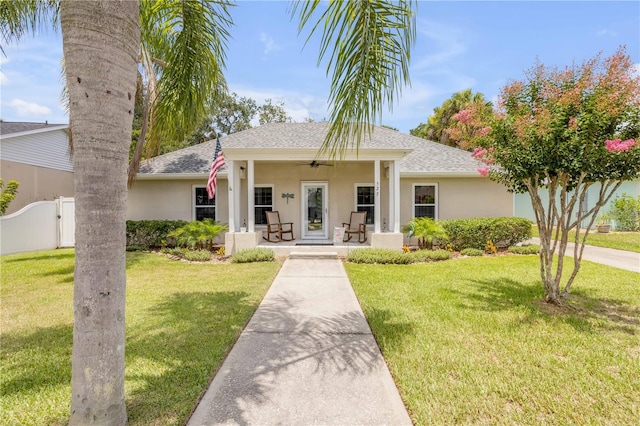 527 Old Minorcan Trl, New Smyrna Beach, FL 32168 - view of front of property featuring a shingled roof, a porch, and stucco siding