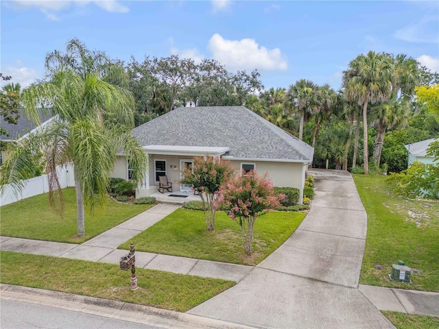 527 Old Minorcan Trl, New Smyrna Beach, FL 32168 - view of front of house featuring covered porch, driveway, stucco siding, and a shingled roof