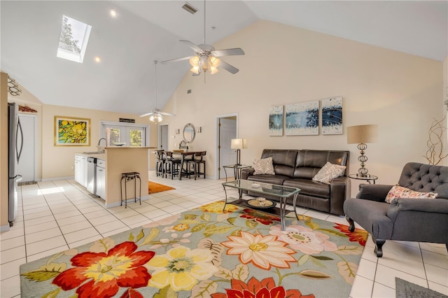 527 Old Minorcan Trl, New Smyrna Beach, FL 32168 - living room featuring ceiling fan, high vaulted ceiling, light tile patterned floors, and a skylight