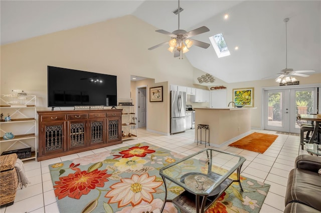 527 Old Minorcan Trl, New Smyrna Beach, FL 32168 - living area featuring ceiling fan, a skylight, light tile patterned floors, and high vaulted ceiling