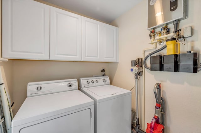 527 Old Minorcan Trl, New Smyrna Beach, FL 32168 - laundry area with washer and dryer, cabinet space, and water heater