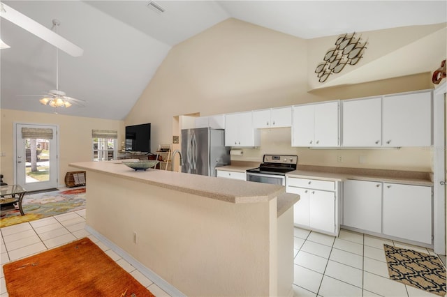 527 Old Minorcan Trl, New Smyrna Beach, FL 32168 - kitchen featuring freestanding refrigerator, electric range oven, light tile patterned floors, high vaulted ceiling, and light countertops