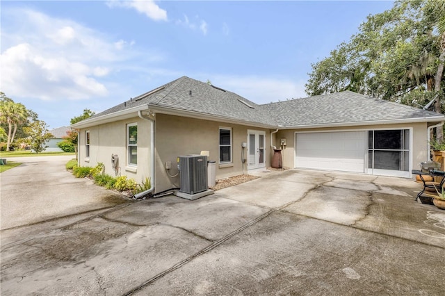 527 Old Minorcan Trl, New Smyrna Beach, FL 32168 - view of front of house featuring stucco siding, roof with shingles, a garage, and driveway