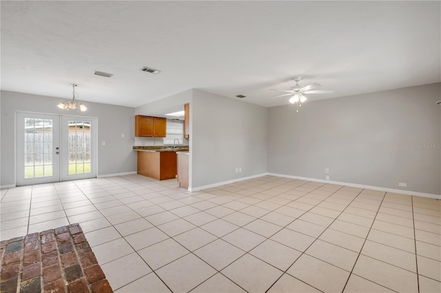 3132 Pine Tree Dr, Edgewater, FL 32141 - unfurnished living room featuring ceiling fan, a chandelier, french doors, and light tile patterned floors