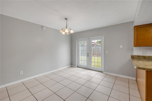 3132 Pine Tree Dr, Edgewater, FL 32141 - unfurnished dining area featuring french doors, a chandelier, and light tile patterned flooring