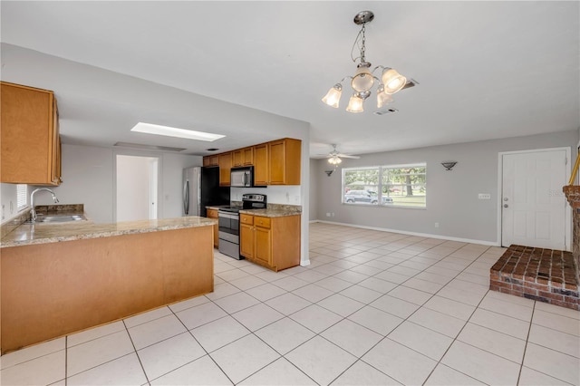3132 Pine Tree Dr, Edgewater, FL 32141 - kitchen with stainless steel appliances, light tile patterned floors, a peninsula, a chandelier, and brown cabinetry