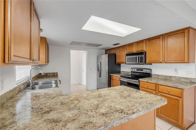 3132 Pine Tree Dr, Edgewater, FL 32141 - kitchen featuring stainless steel appliances, light countertops, light tile patterned floors, a skylight, and brown cabinets