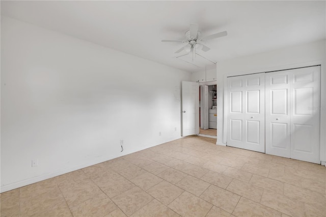 3132 Pine Tree Dr, Edgewater, FL 32141 - unfurnished bedroom featuring light tile patterned floors, a closet, washer / dryer, and a ceiling fan