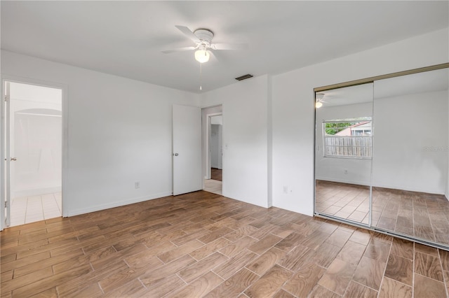 3132 Pine Tree Dr, Edgewater, FL 32141 - unfurnished bedroom with wood finished floors, ensuite bathroom, a ceiling fan, and a closet