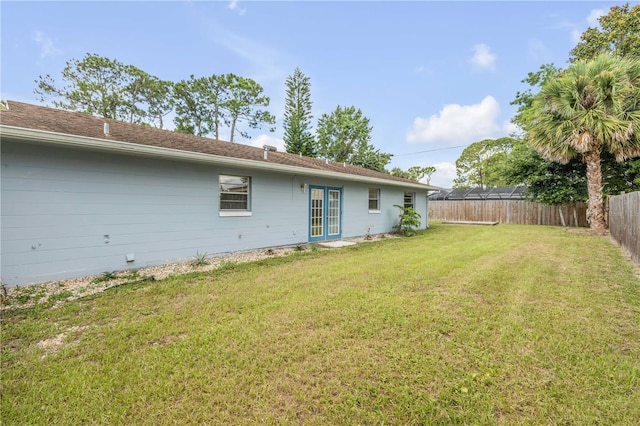 3132 Pine Tree Dr, Edgewater, FL 32141 - fenced backyard featuring french doors