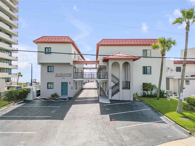 1404 N Atlantic Ave Unit 70, Daytona Beach, FL 32118 - view of building exterior with uncovered parking