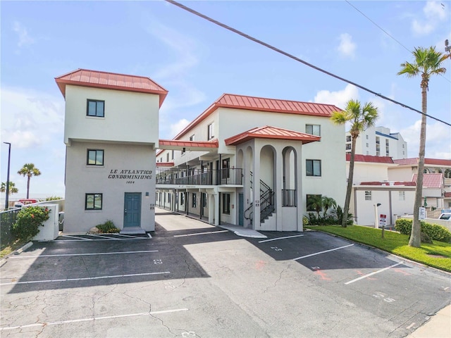1404 N Atlantic Ave Unit 70, Daytona Beach, FL 32118 - view of building exterior with uncovered parking and stairs