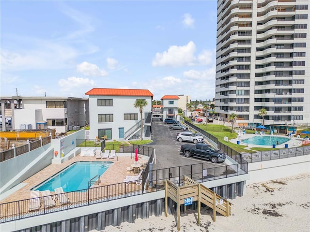 1404 N Atlantic Ave Unit 70, Daytona Beach, FL 32118 - community pool featuring stairs, a fenced backyard, and a patio area