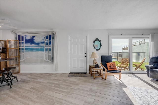 1404 N Atlantic Ave Unit 70, Daytona Beach, FL 32118 - living room featuring a ceiling fan and light wood finished floors
