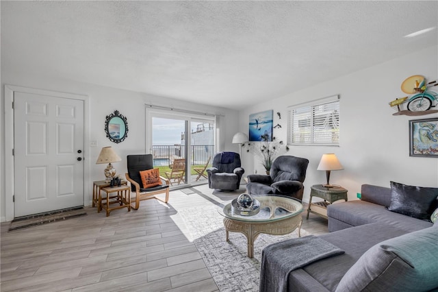 1404 N Atlantic Ave Unit 70, Daytona Beach, FL 32118 - living area featuring a textured ceiling and wood finished floors