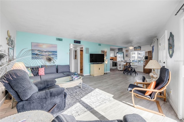 1404 N Atlantic Ave Unit 70, Daytona Beach, FL 32118 - living area featuring ceiling fan and light wood-style flooring