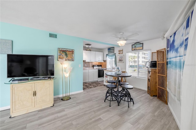 1404 N Atlantic Ave Unit 70, Daytona Beach, FL 32118 - dining room with ceiling fan and light wood-style floors