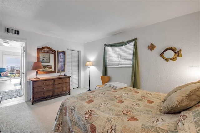 1404 N Atlantic Ave Unit 70, Daytona Beach, FL 32118 - bedroom with light carpet and access to outside