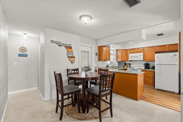 211 Fox Pl, Port Orange, FL 32127 - dining space with a textured ceiling and dark aggregate flooring