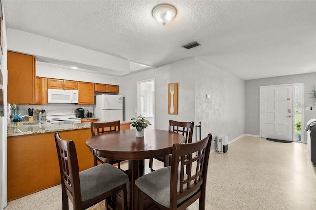 211 Fox Pl, Port Orange, FL 32127 - dining area featuring a textured ceiling and dark speckled floor
