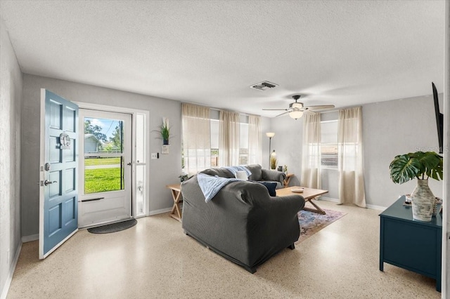 211 Fox Pl, Port Orange, FL 32127 - living area featuring plenty of natural light, speckle patterned floor, a textured ceiling, and ceiling fan
