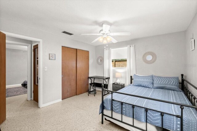 211 Fox Pl, Port Orange, FL 32127 - bedroom featuring a closet, dark aggregate flooring, and a ceiling fan