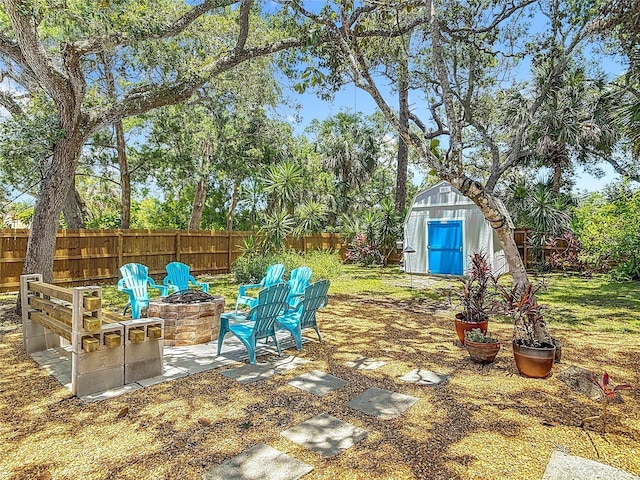 657 S Pine St, New Smyrna Beach, FL 32169 - fenced backyard with a fire pit and a shed