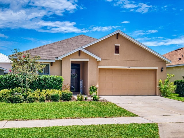 2731 Star Coral Ln, New Smyrna Beach, FL 32168 - view of front of property featuring stucco siding, an attached garage, concrete driveway, and a front yard