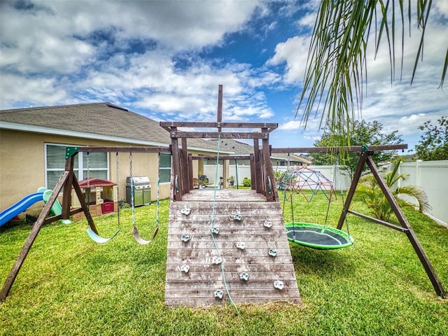 2731 Star Coral Ln, New Smyrna Beach, FL 32168 - rear view of house featuring a playground, a fenced backyard, and stucco siding