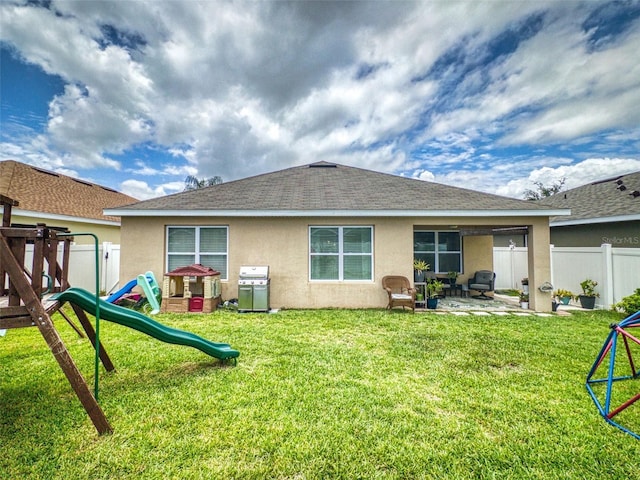 2731 Star Coral Ln, New Smyrna Beach, FL 32168 - rear view of property featuring a playground, stucco siding, and a patio area